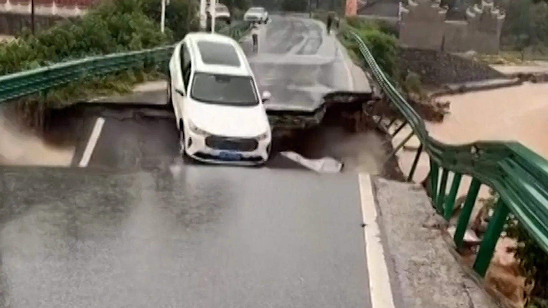 Car swept away by floodwater after bridge collapses in China