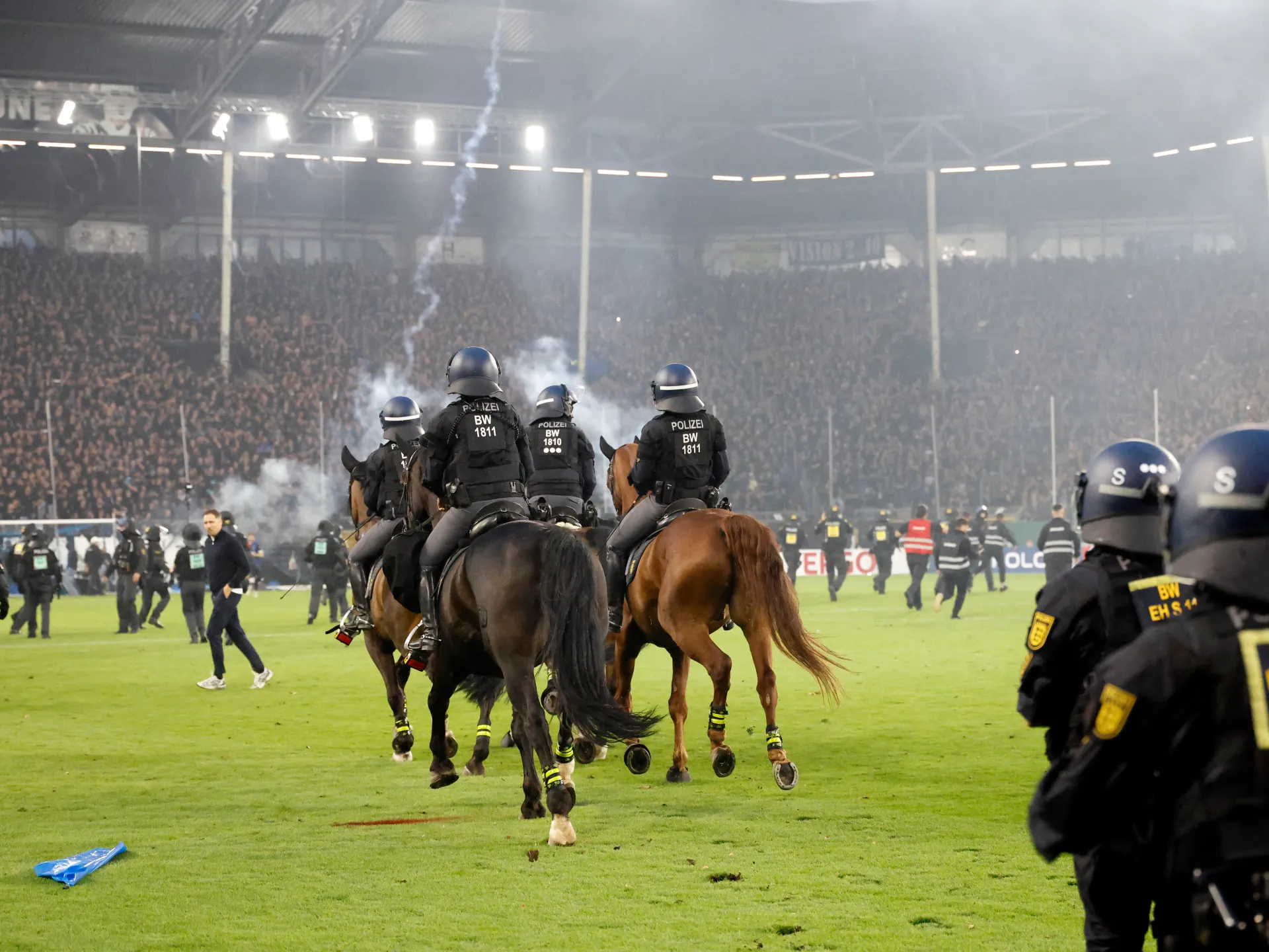 Fans and police injured in pitch invasion during ‘high risk’ German Cup tie