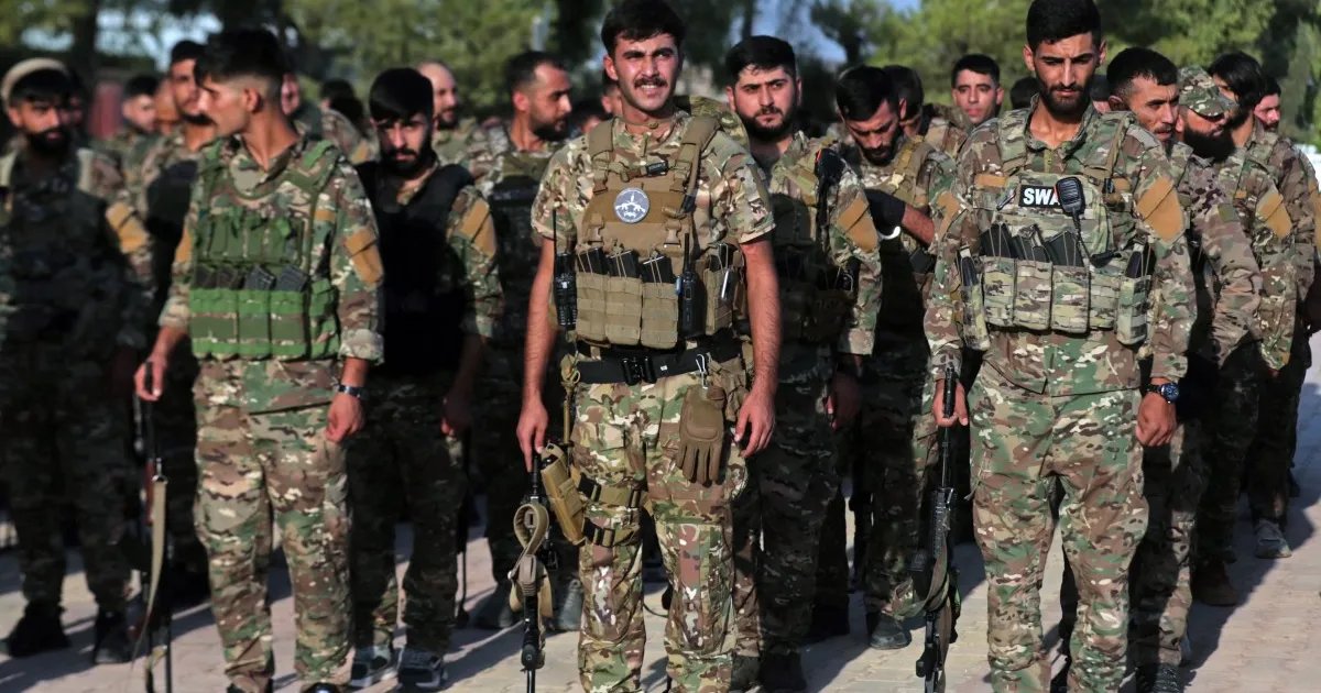 Kurdish-led forces in Syria dissolve after merging with the army
