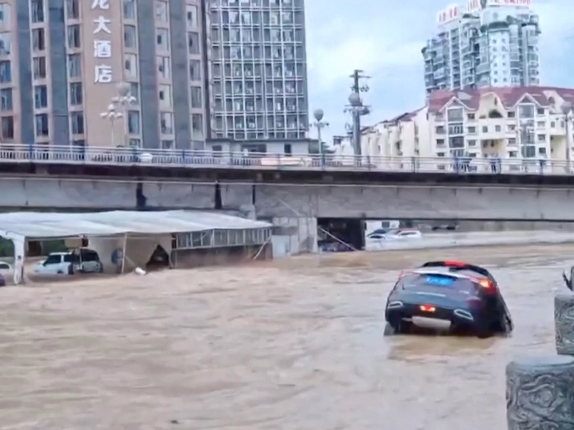 Flooding in southern China washes away cars and destroys bridge